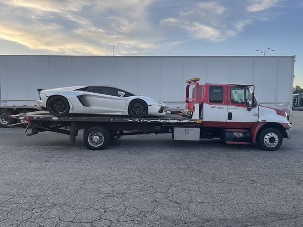 Tow truck transporting a sports car