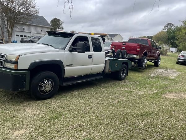 Pickup truck towing a trailer with another vehicle